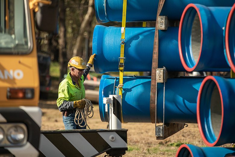 Man inspecting pipes for Dungowan pipeline project.