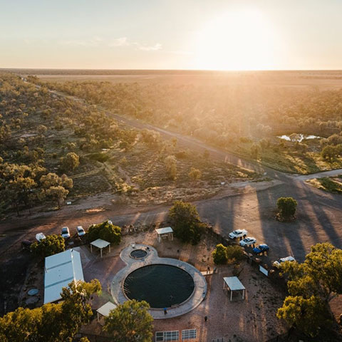 Aerial view of the Lightning Ridge landscape with a bore bath in the foreground.